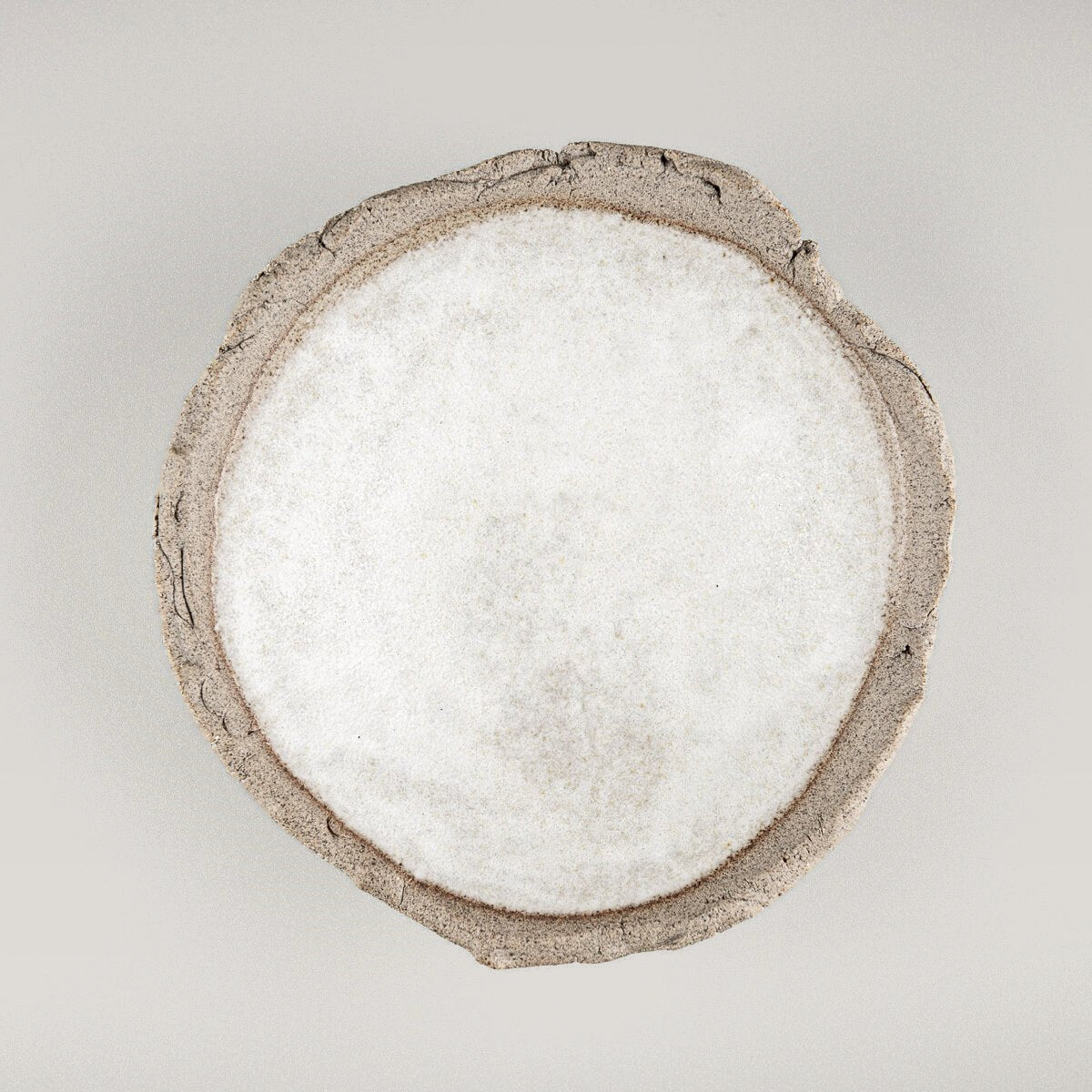 Top view of small oval stoneware sushi plate with smooth glazed center.