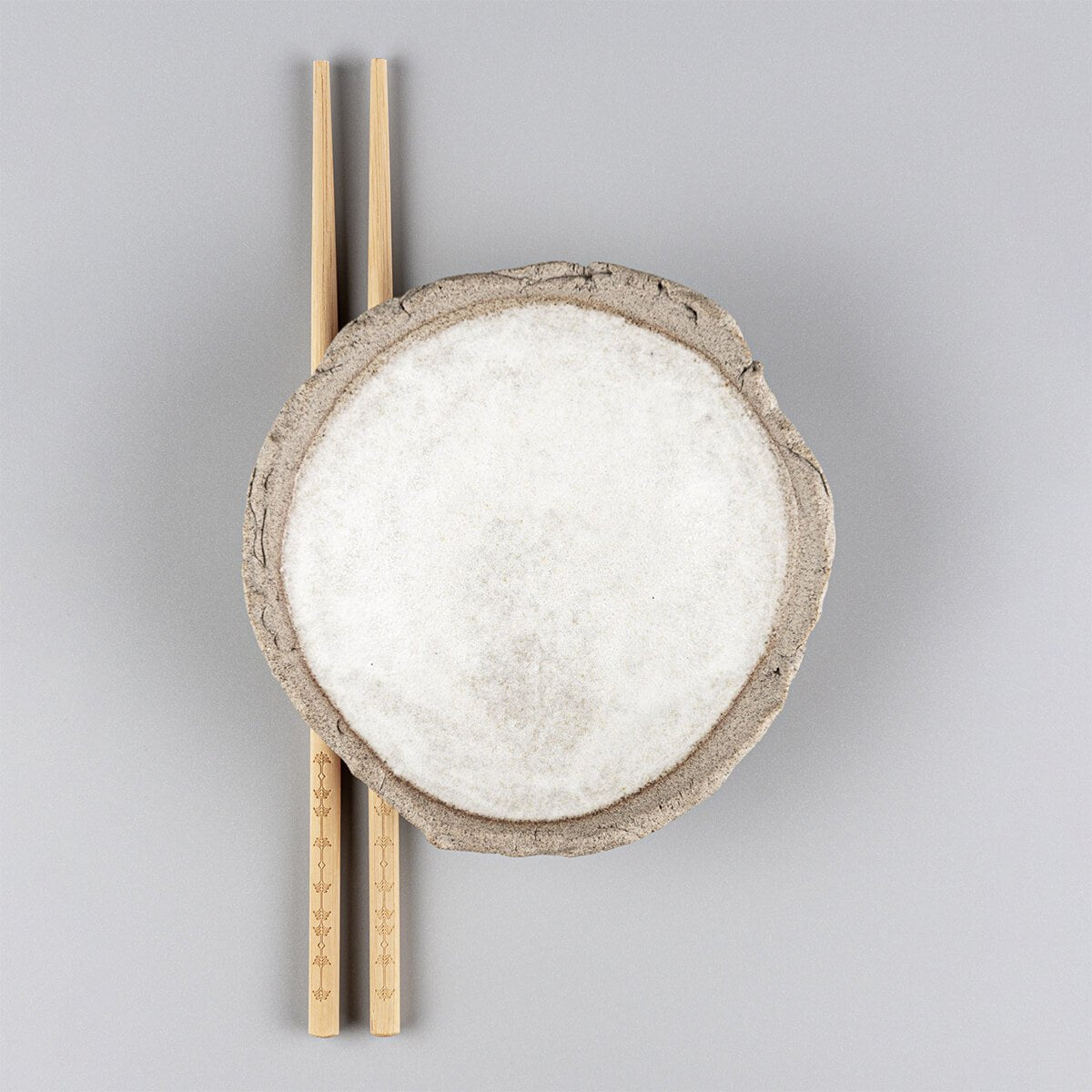 Handmade stoneware sushi plate with white matte glazed interior and textured rim.