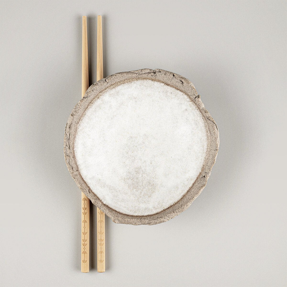 Handmade stoneware sushi plate with white matte glazed interior and textured rim.