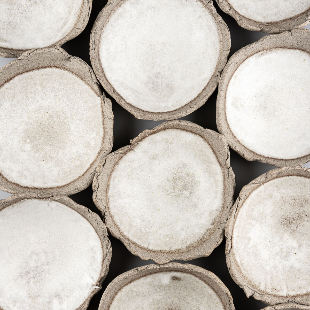 Collection of artisanal stoneware sushi plates arranged for fine dining presentation.