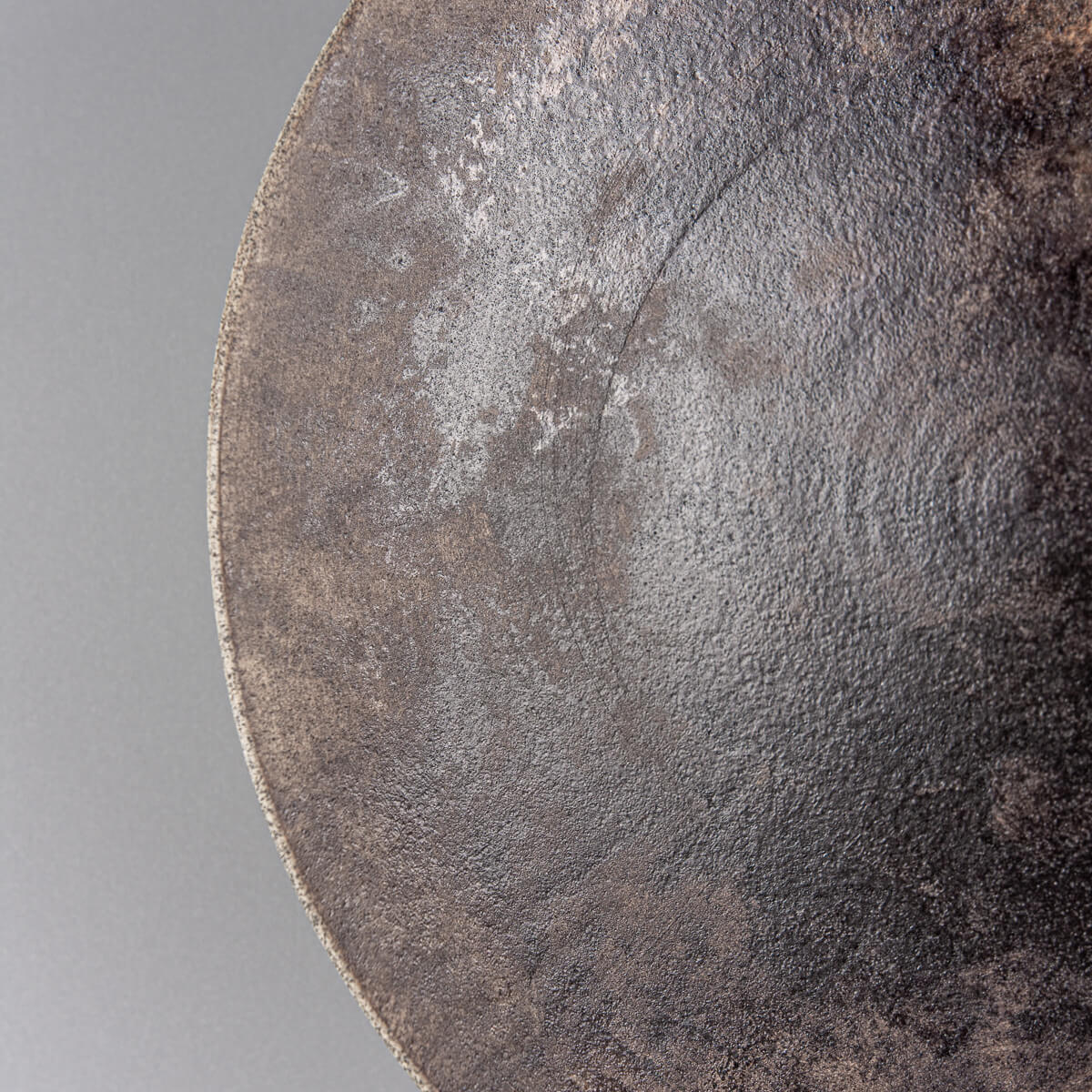 Close-up of artisan stoneware plate with captivating glaze details.
