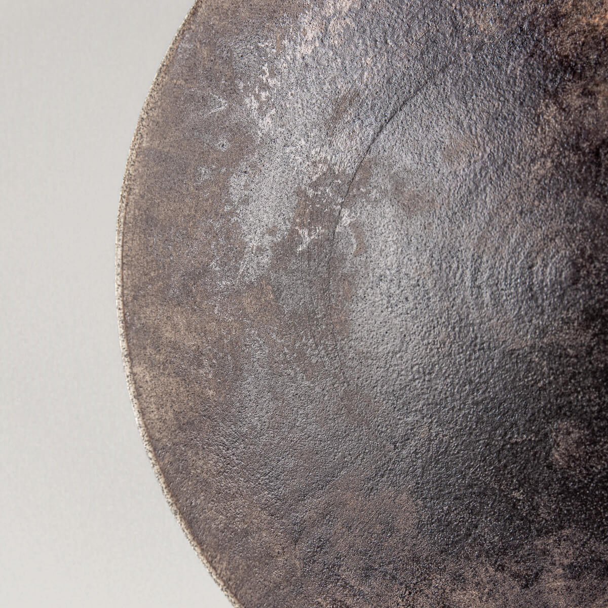 Close-up of artisan stoneware plate with captivating glaze details.