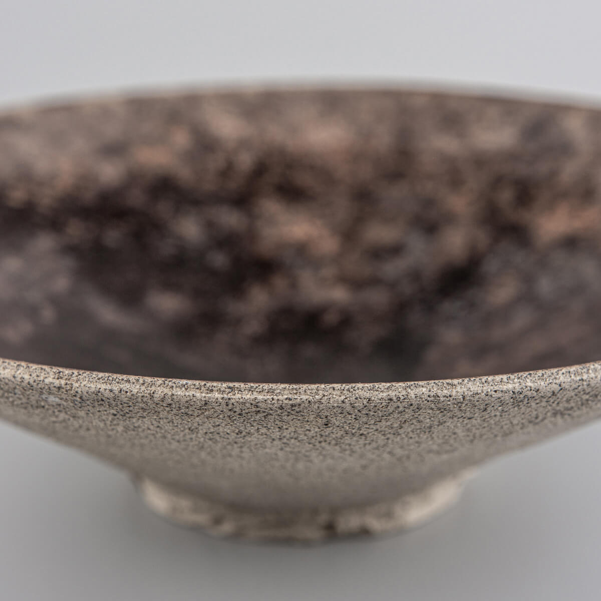 Natural unglazed exterior of artisan stoneware plate highlighting craftsmanship.