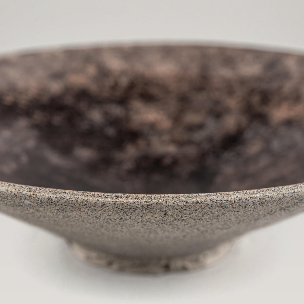 Natural unglazed exterior of artisan stoneware plate highlighting craftsmanship.