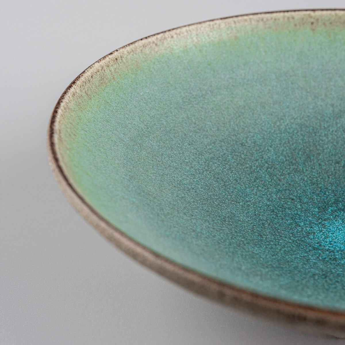 Rustic yet refined handmade ceramic plate for luxury culinary presentation.