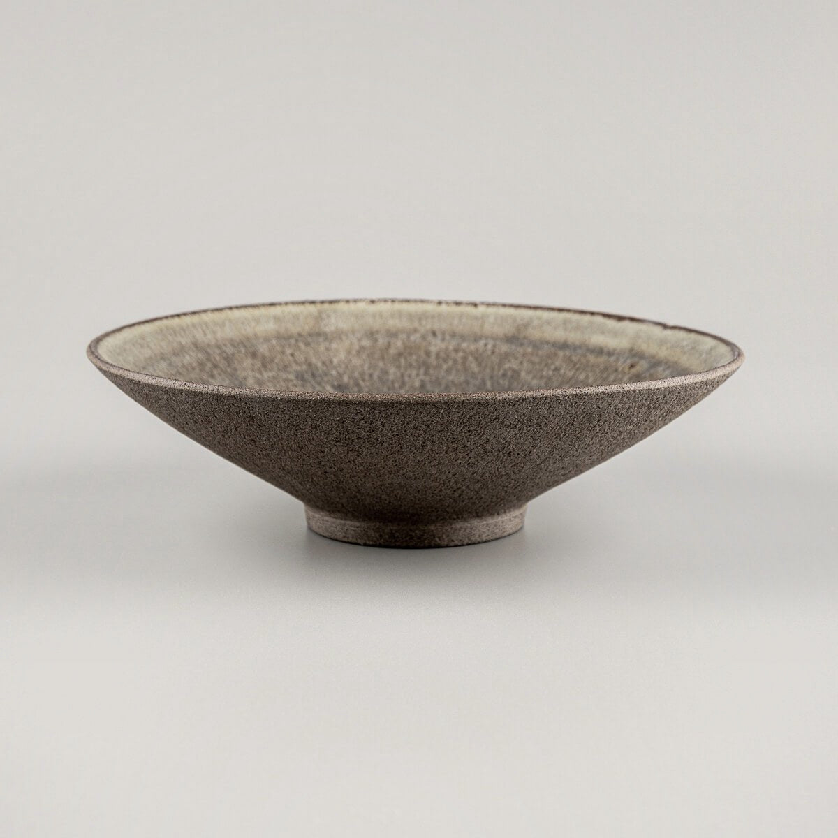 Handcrafted ceramic dinner plate with artisanal olive-green glaze and unglazed clay exterior.