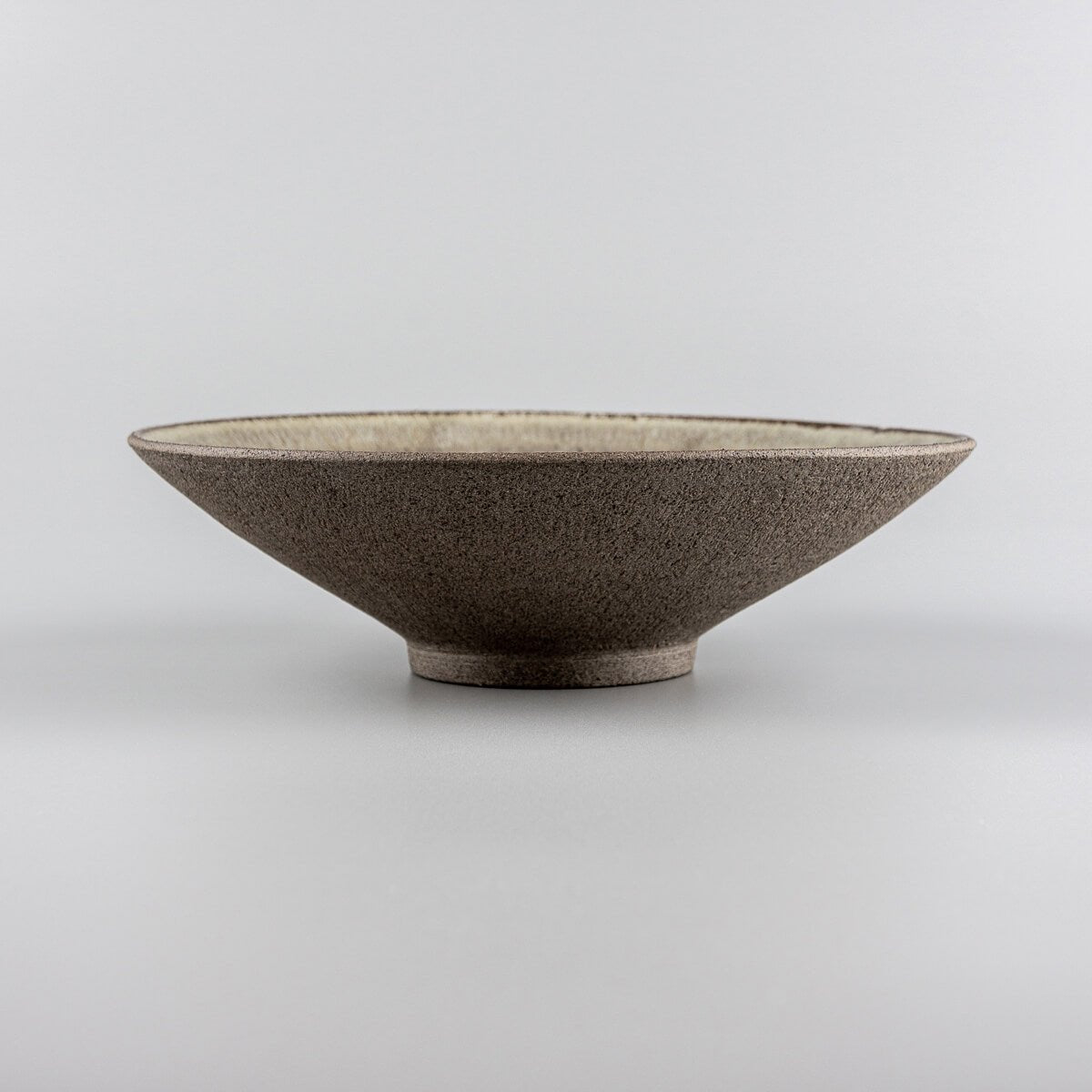 Close-up of artisanal ceramic dinner plate glaze detail for gourmet food presentation.