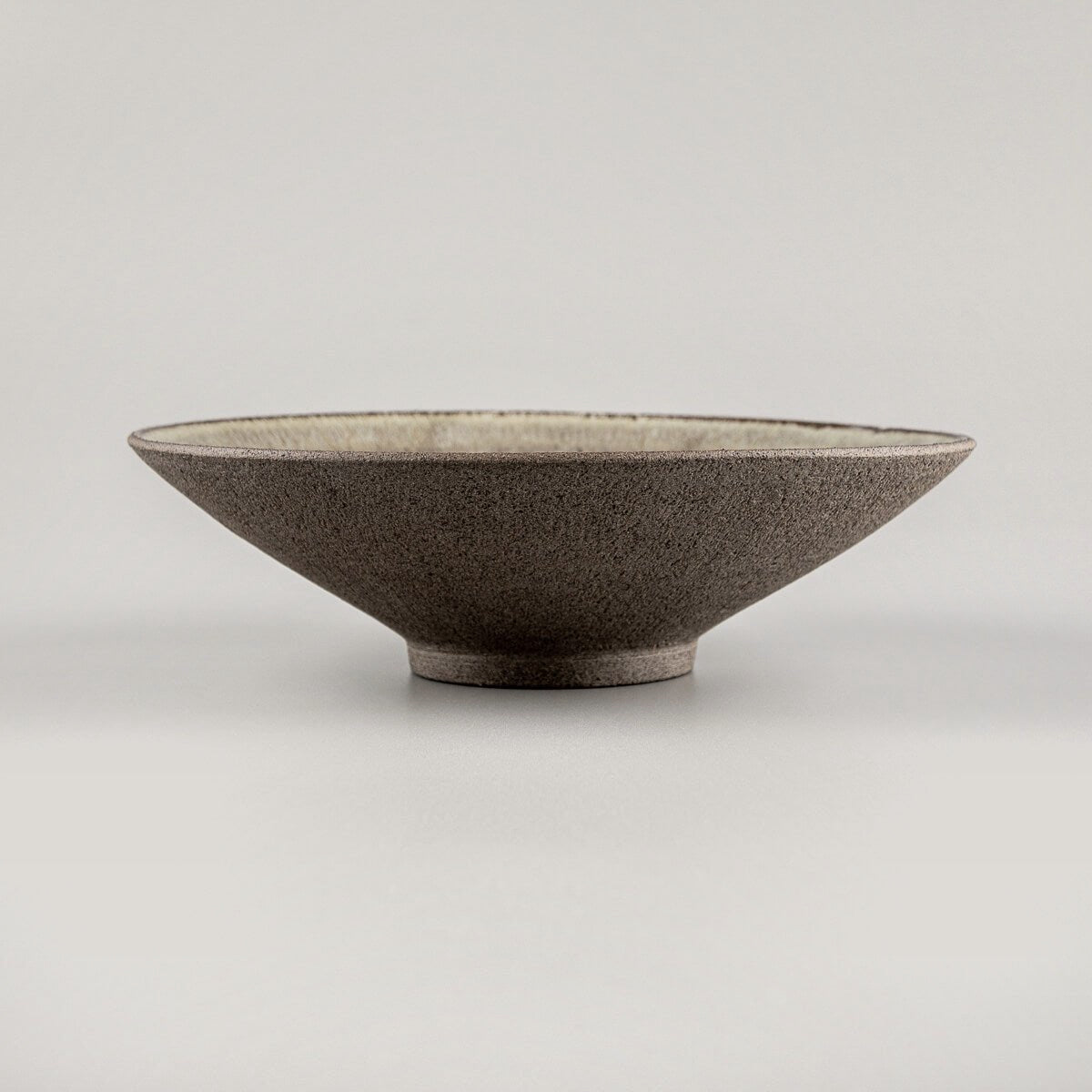Close-up of artisanal ceramic dinner plate glaze detail for gourmet food presentation.