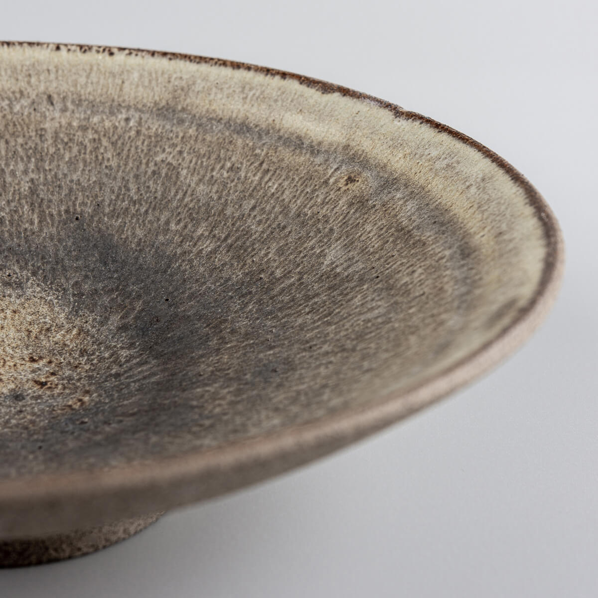 Elegant handcrafted ceramic dinner plate displayed for gourmet plating.