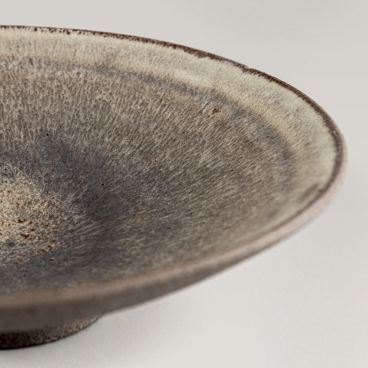 Elegant handcrafted ceramic dinner plate displayed for gourmet plating.