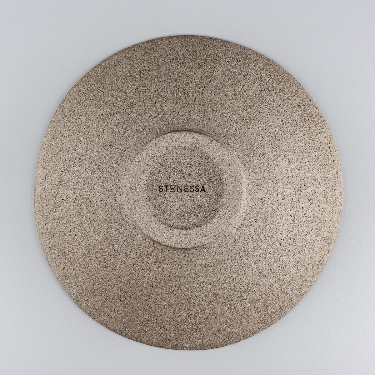 Artisan ceramic dinner plate base view showcasing unglazed textured clay and embossed maker’s mark.