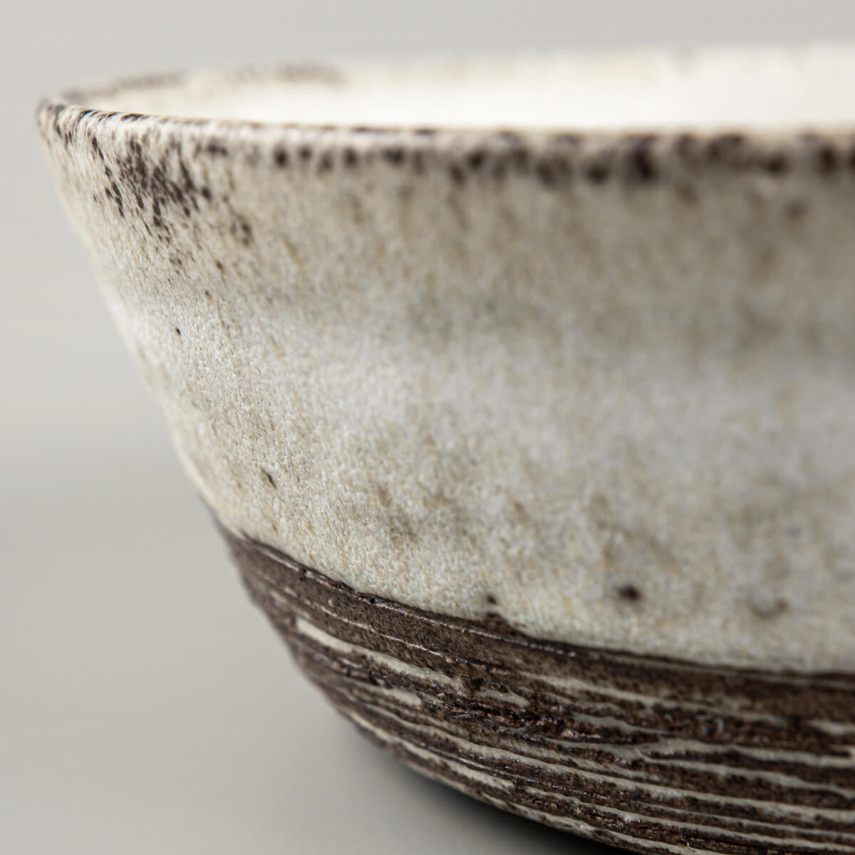 Handmade pottery bowl showcasing textural contrast and artisanal craftsmanship.