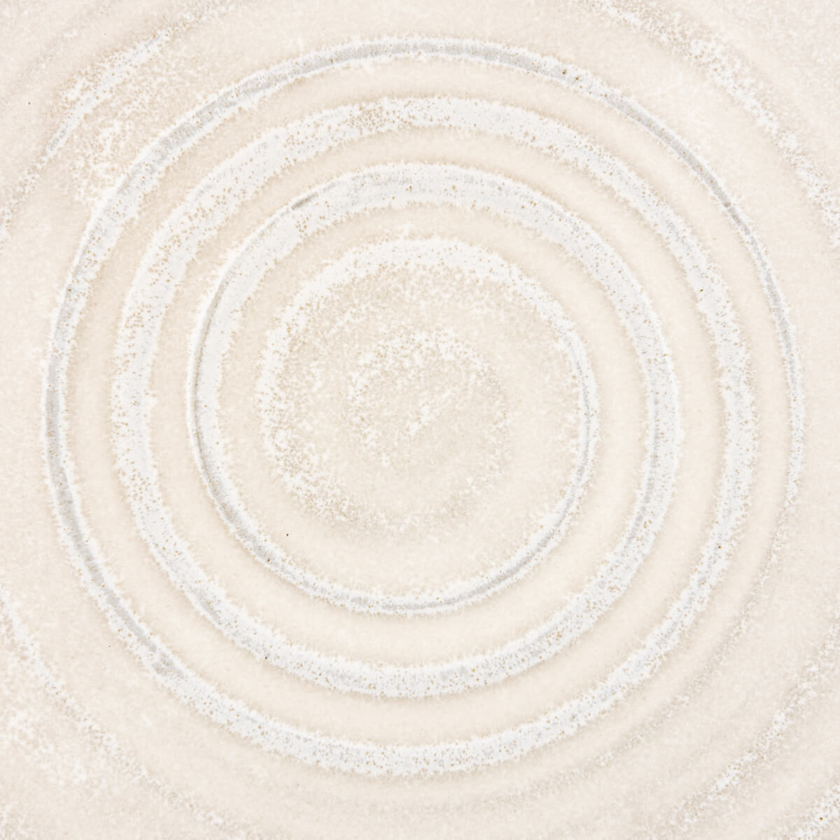 Close-up of textured spiral pattern on handmade stoneware plate for culinary presentation.