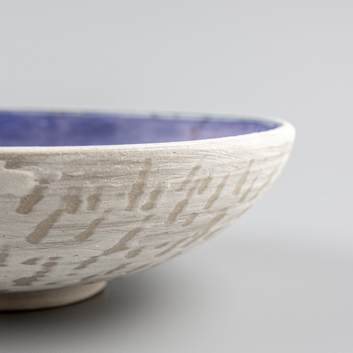 Perspective view showing glaze depth and textured patterns inside ceramic bowl.