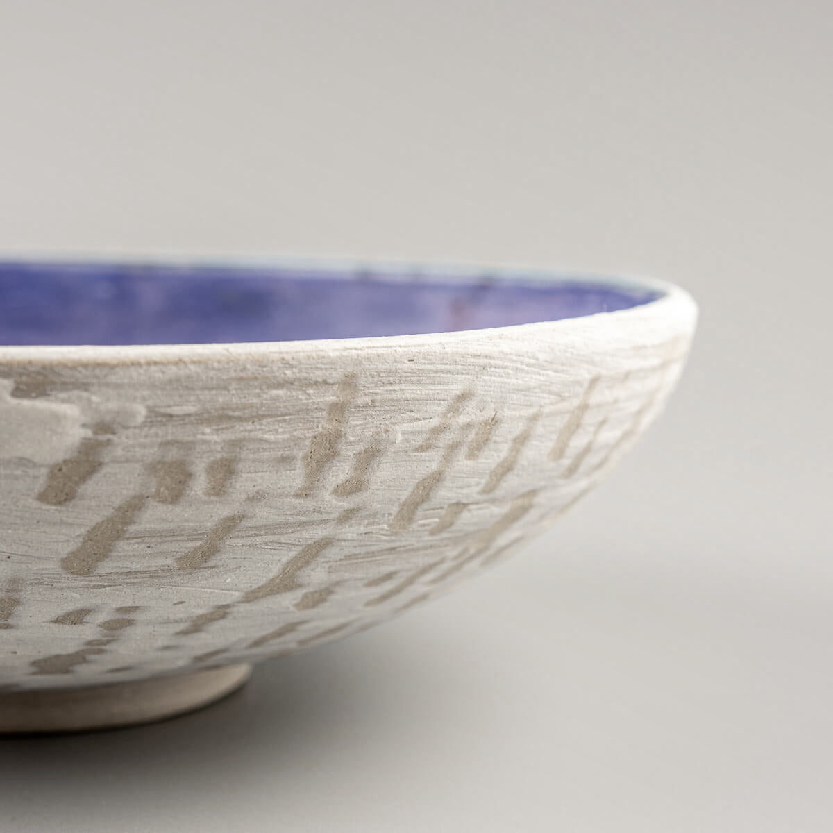Perspective view showing glaze depth and textured patterns inside ceramic bowl.