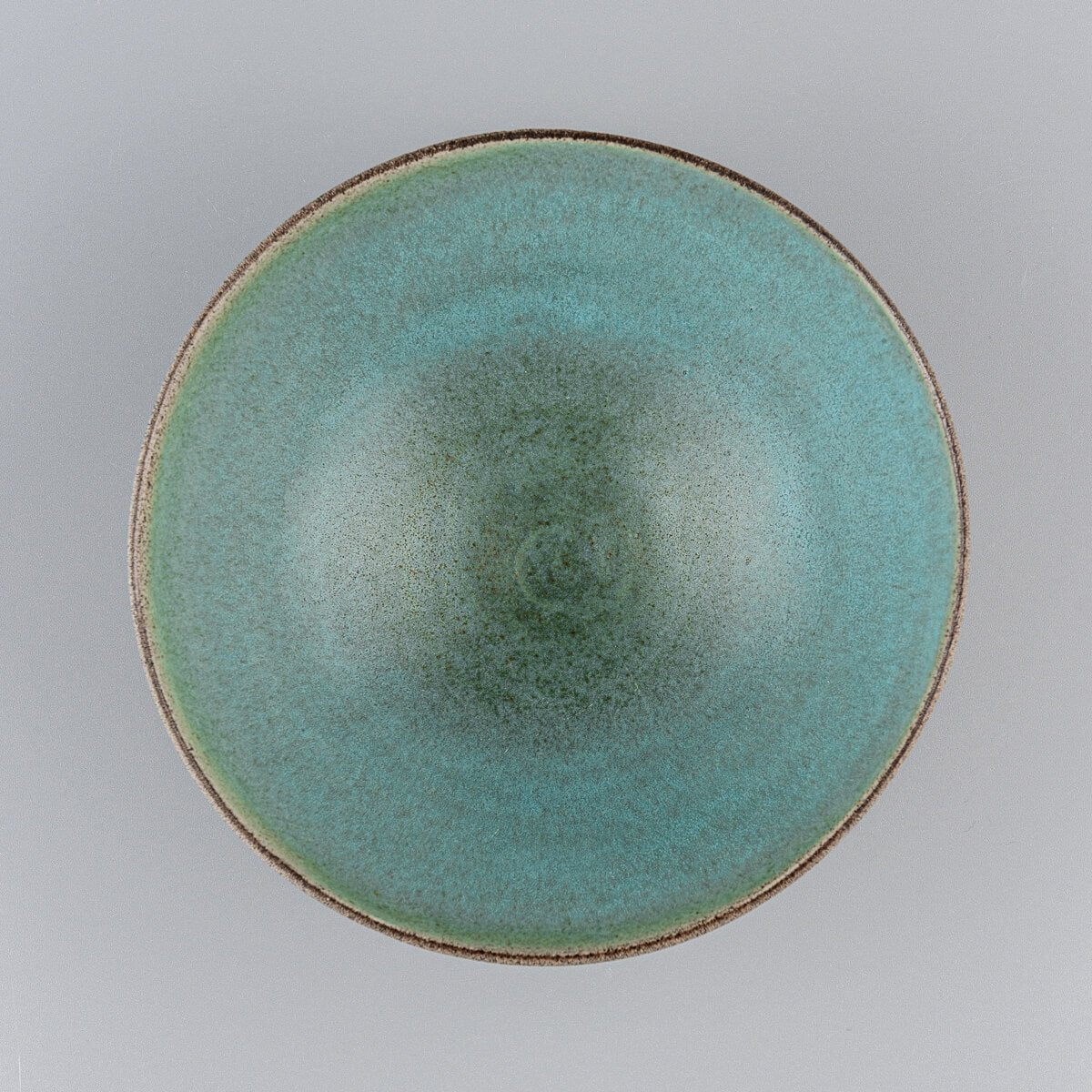 Top-down view of ceramic bowl showing circular shape and smooth aqua glaze.