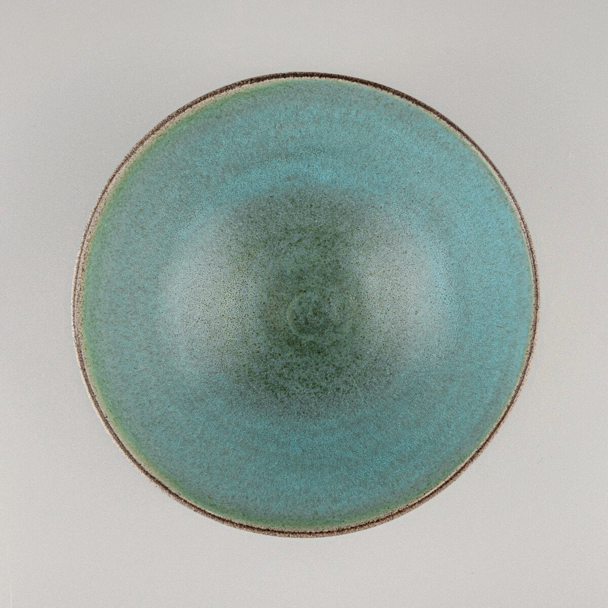 Top-down view of ceramic bowl showing circular shape and smooth aqua glaze.