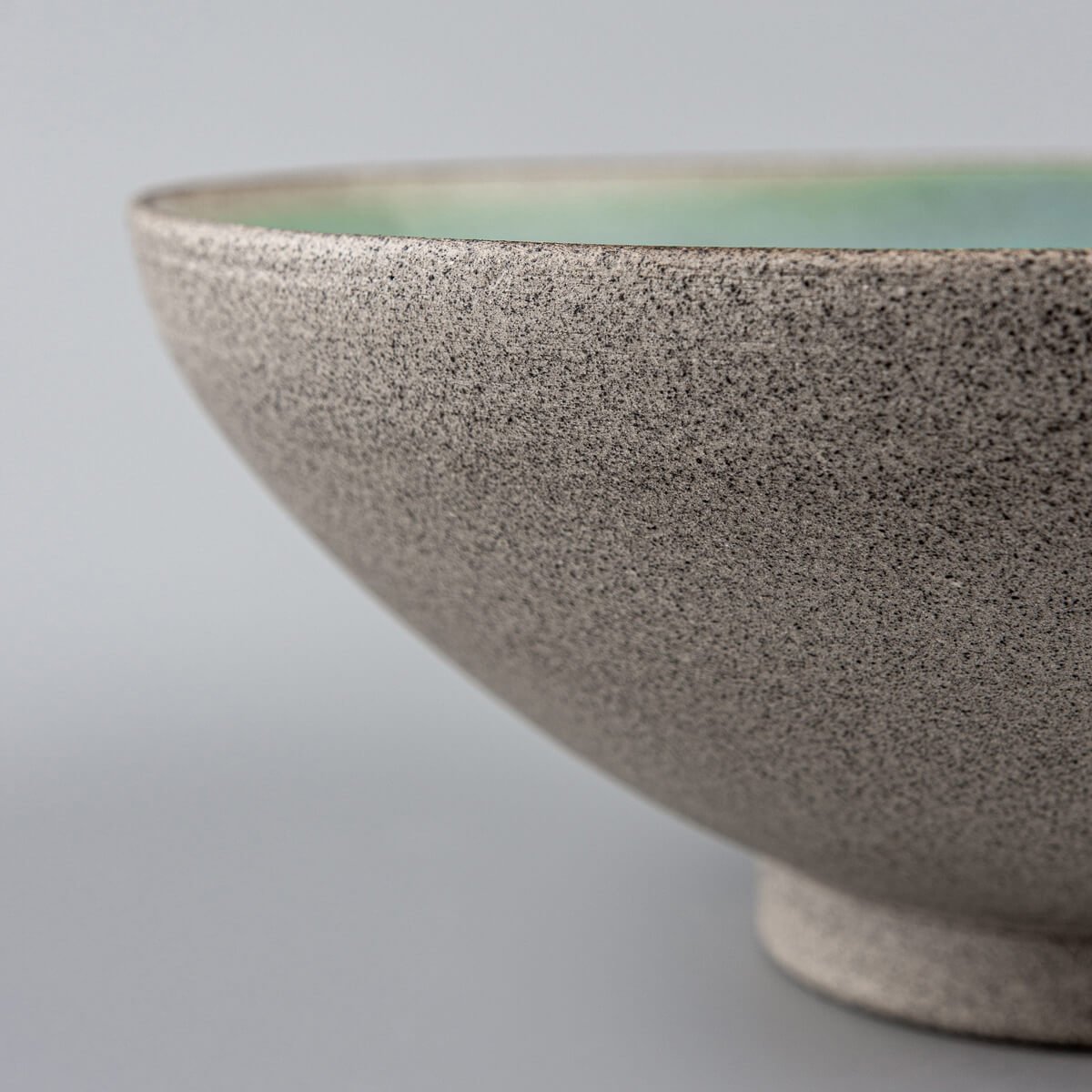 Textured outer surface of ceramic bowl revealing natural unglazed clay.