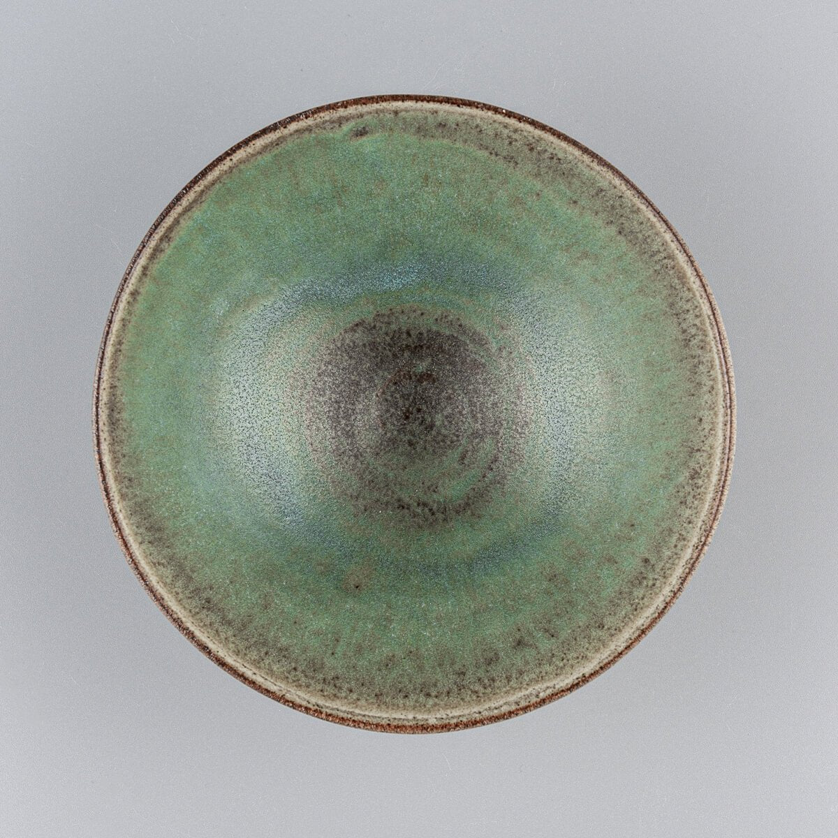Top view of handmade bowl showcasing matte green ceramic glaze for elegant serving.