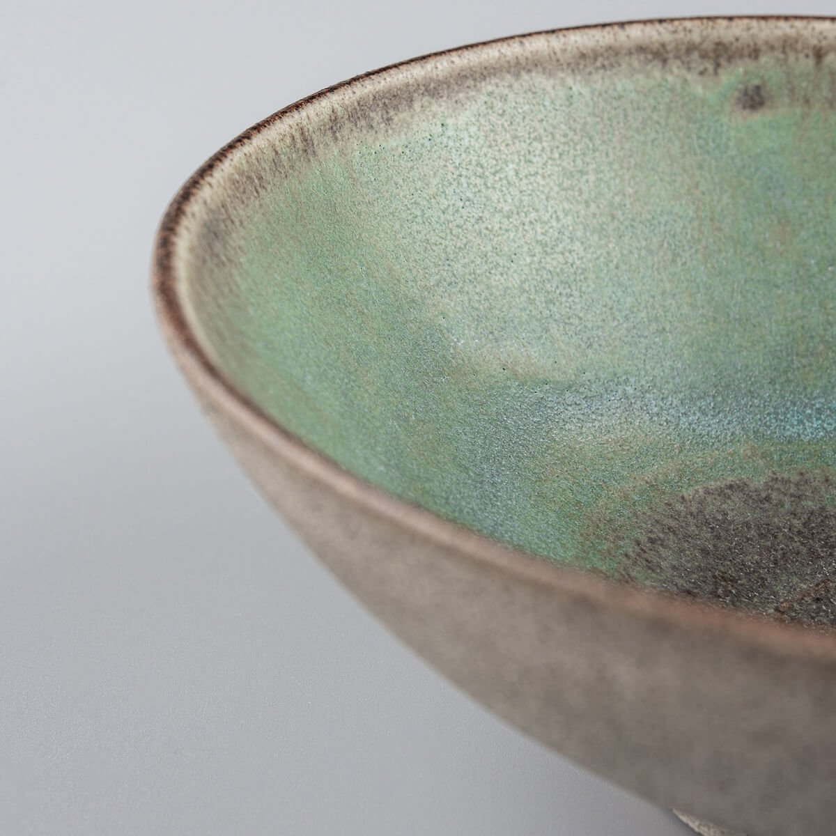 Close-up of green glazed ceramic interior, perfect for culinary presentation or gifting.