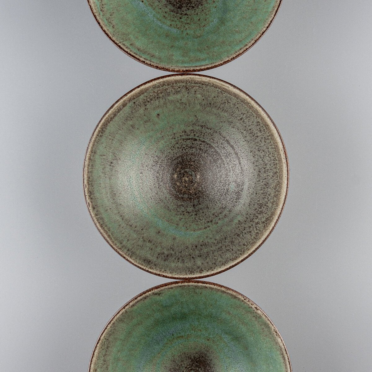 Collection of green interior ceramic bowls for home, gift, or collectible tableware.