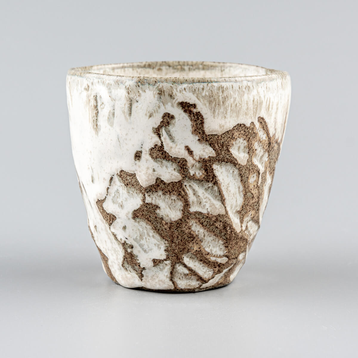 Handmade ceramic mug with carved stoneware details and white matte glaze for fine dining and boutique hotels.