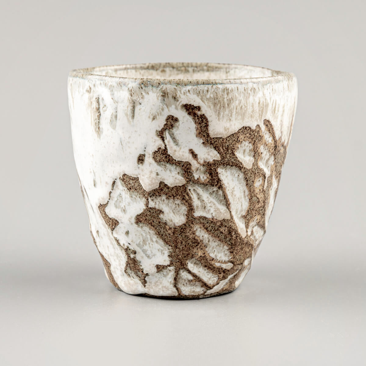 Handmade ceramic mug with carved stoneware details and white matte glaze for fine dining and boutique hotels.