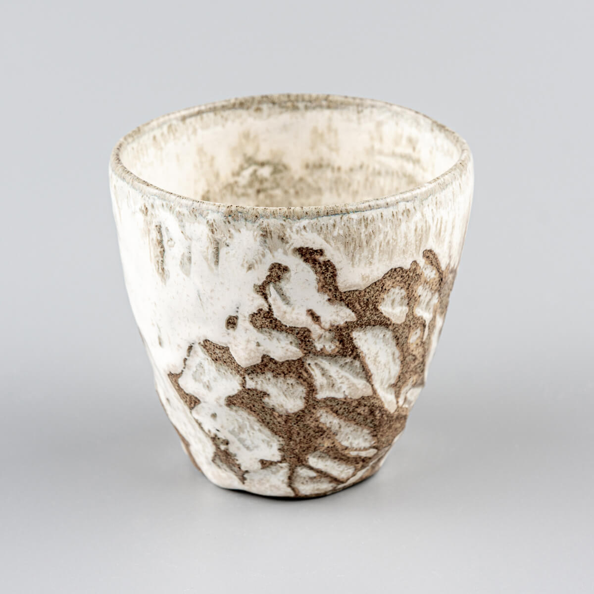 Elegant handmade mug with unique carved patterns, perfect for coffee, tea, or matcha tea rituals at home.