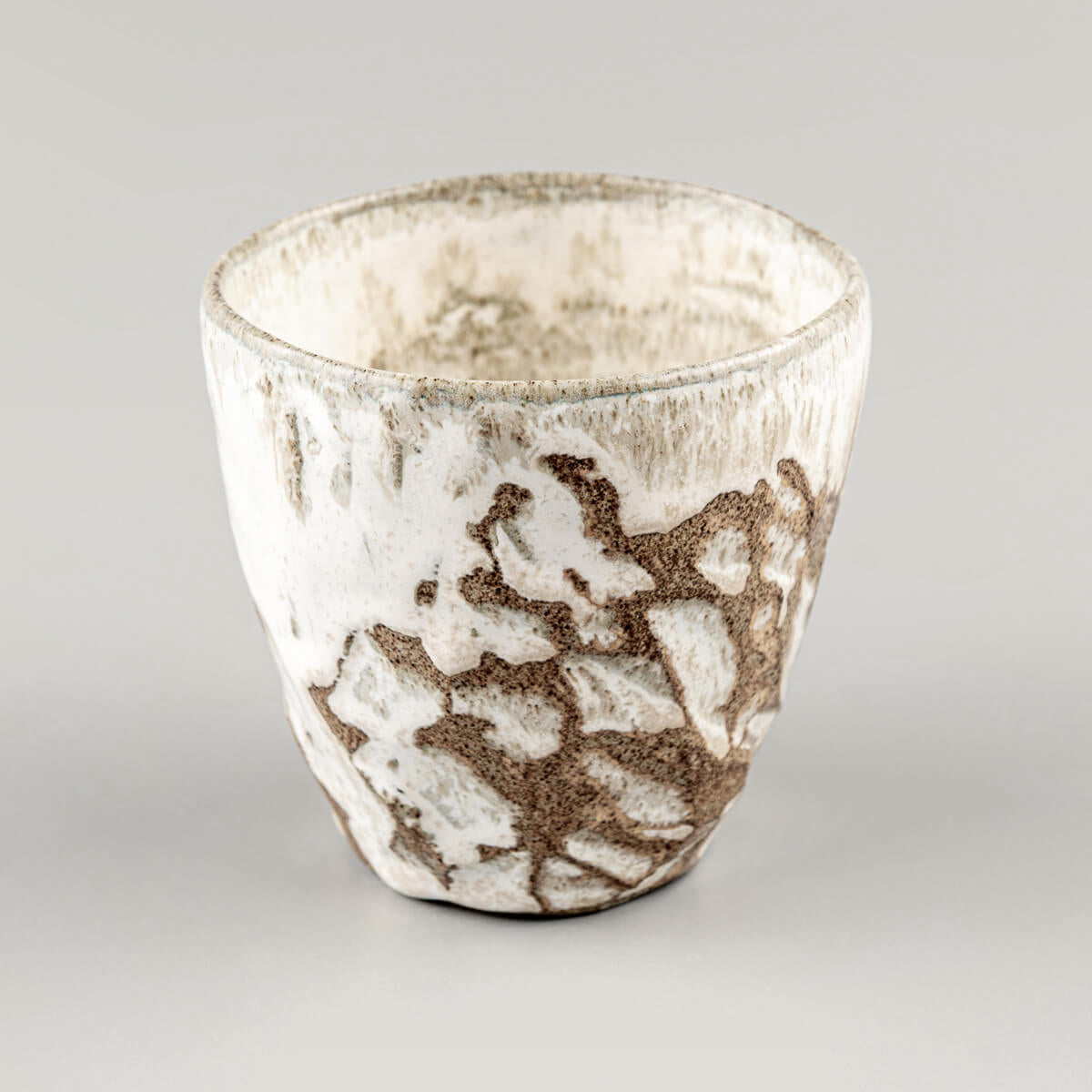 Elegant handmade mug with unique carved patterns, perfect for coffee, tea, or matcha tea rituals at home.