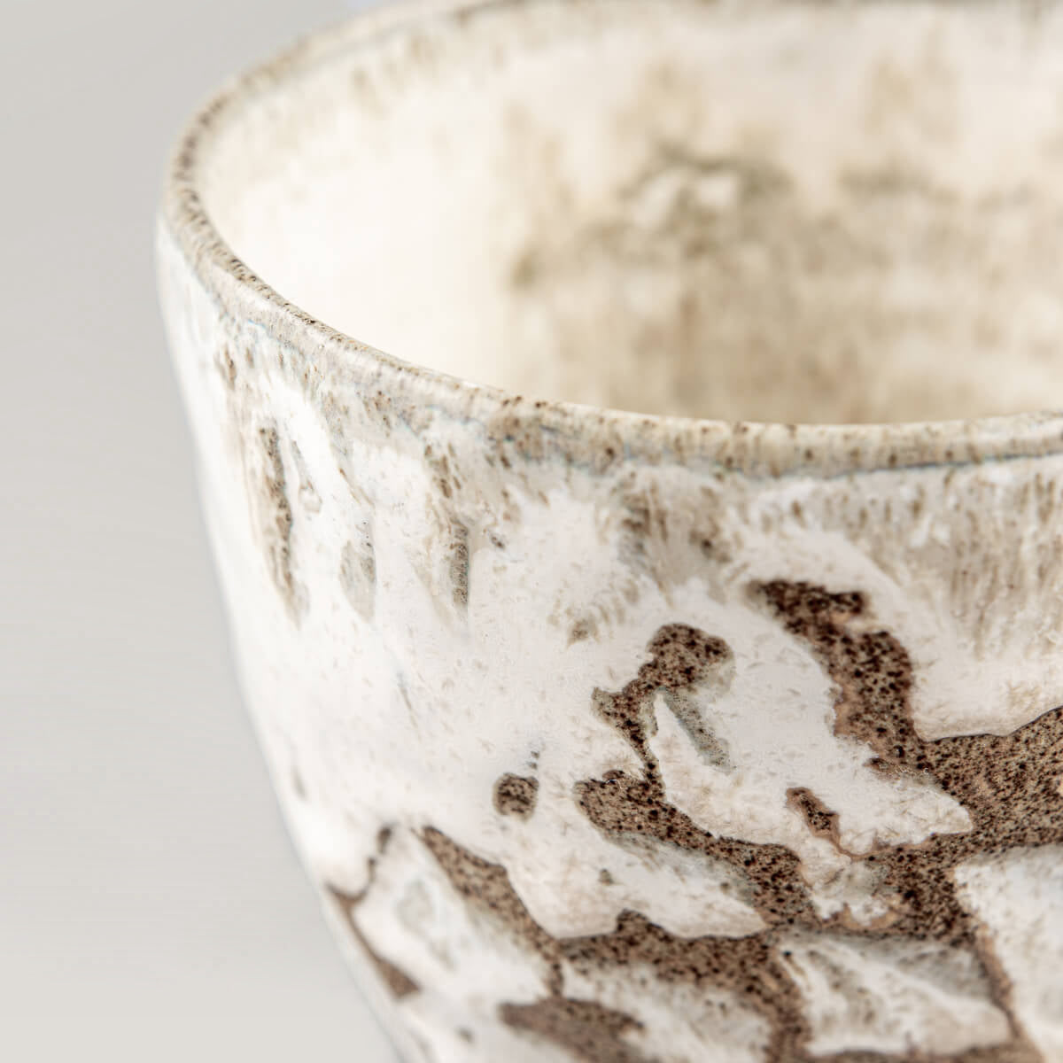 Rustic ceramic mug with white matte glaze and natural clay texture for restaurants and culinary presentation.
