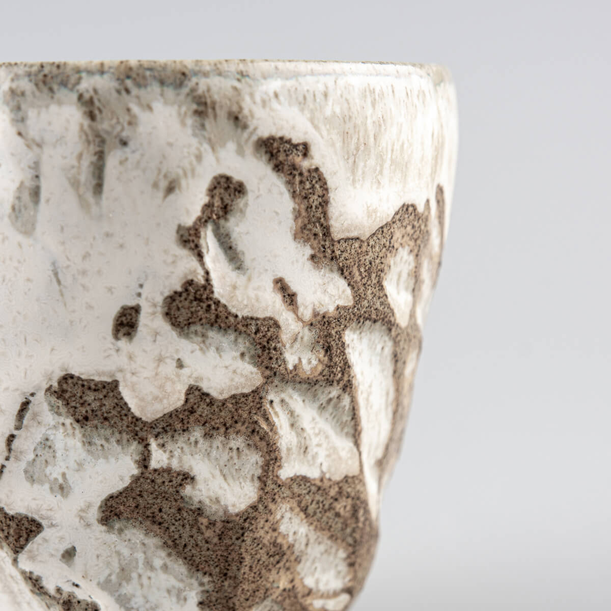 Unique handmade ceramic mug with artisanal carving and glaze, designed for fine dining chefs and private collectors.