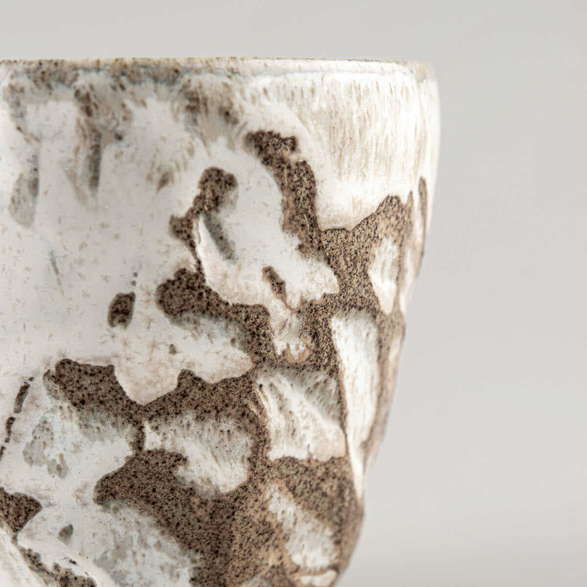 Unique handmade ceramic mug with artisanal carving and glaze, designed for fine dining chefs and private collectors.
