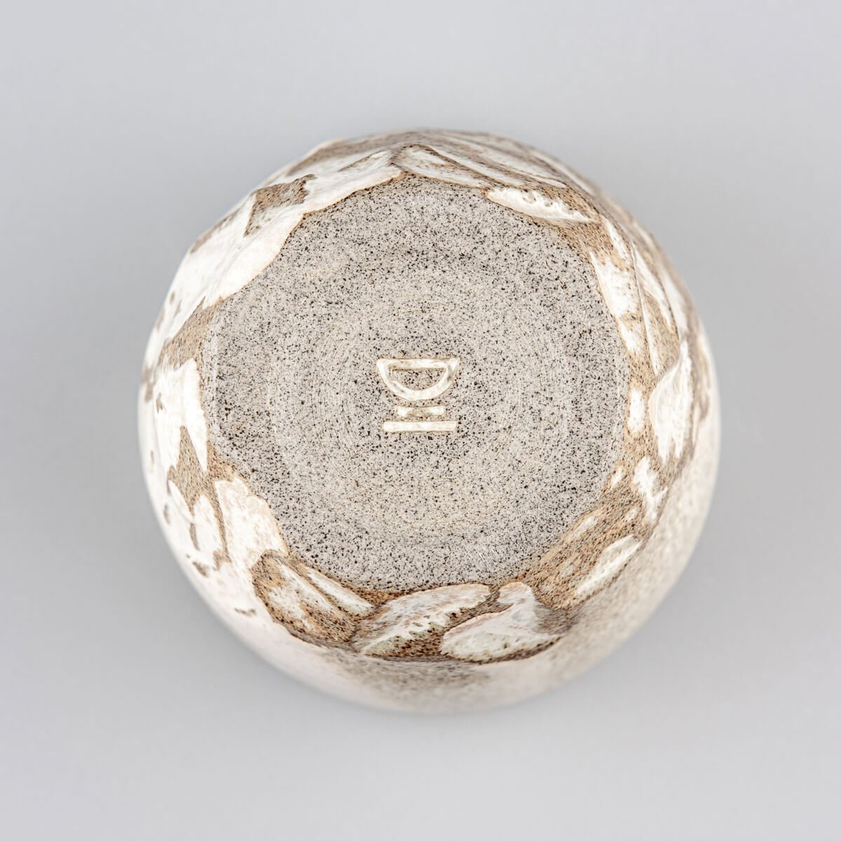 Bottom view of handmade ceramic mug with textured base and rustic glaze, crafted for collectible pottery and decor.
