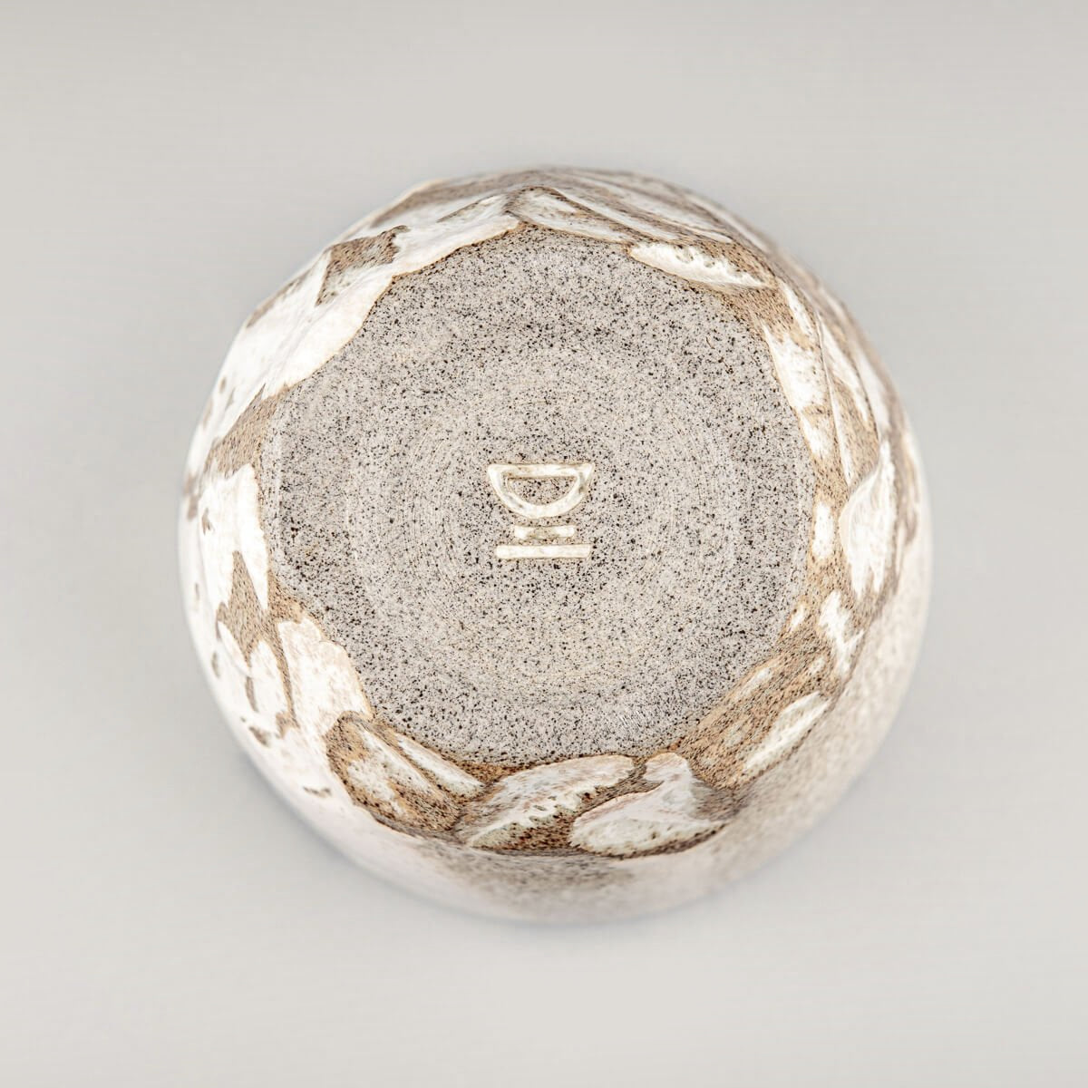 Bottom view of handmade ceramic mug with textured base and rustic glaze, crafted for collectible pottery and decor.