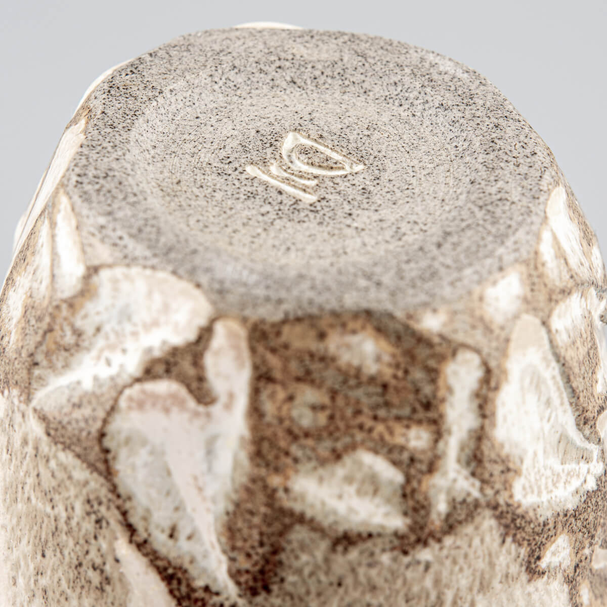 Stoneware ceramic mug with matte glaze and organic details, perfect for home, hotel, and handmade decor.