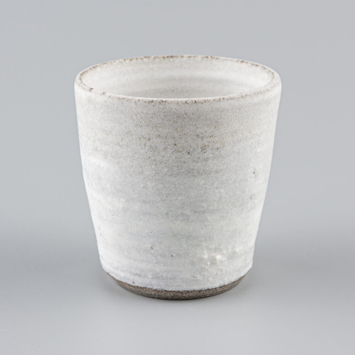 Rustic white stoneware mug crafted for coffee lovers and interior design collections.