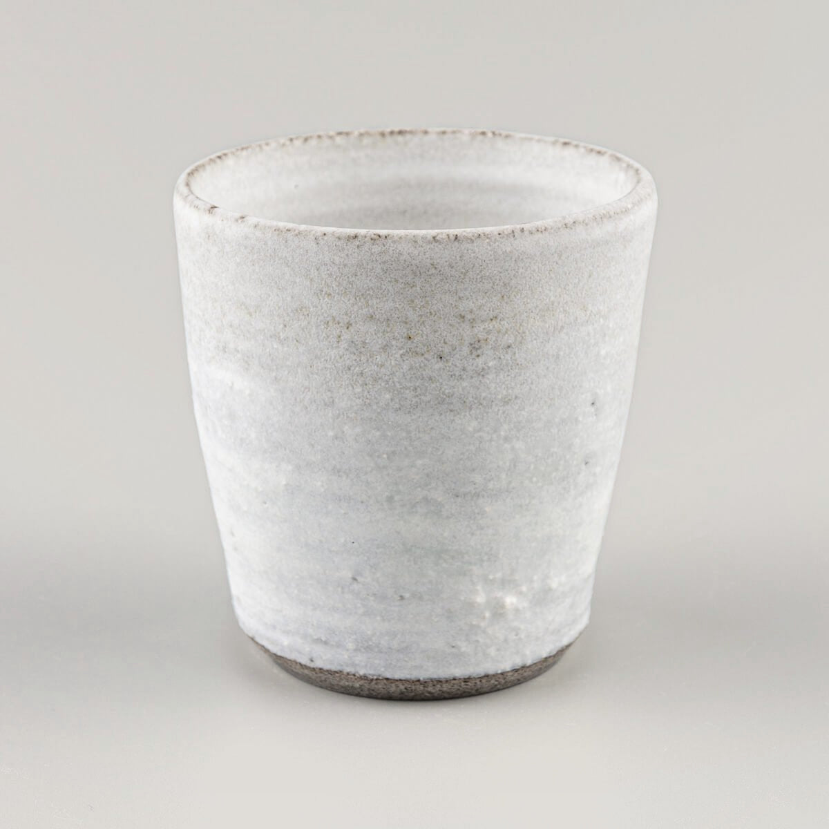 Rustic white stoneware mug crafted for coffee lovers and interior design collections.