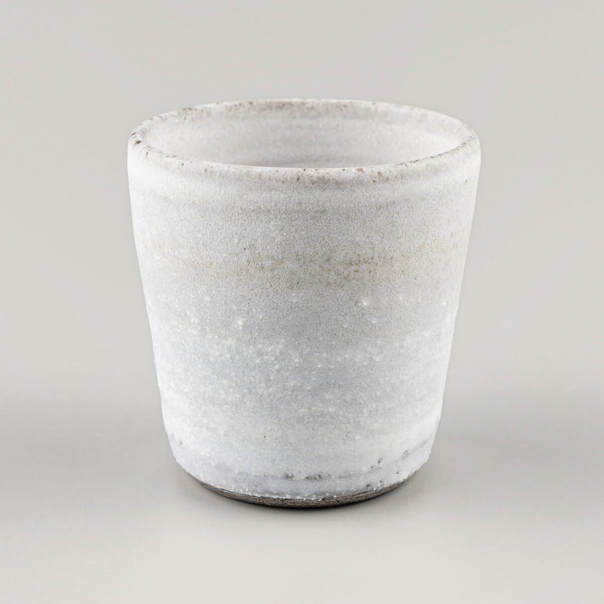Handcrafted stoneware mug with white matte glaze, ideal for coffee, tea, matcha, and modern home or restaurant tableware.