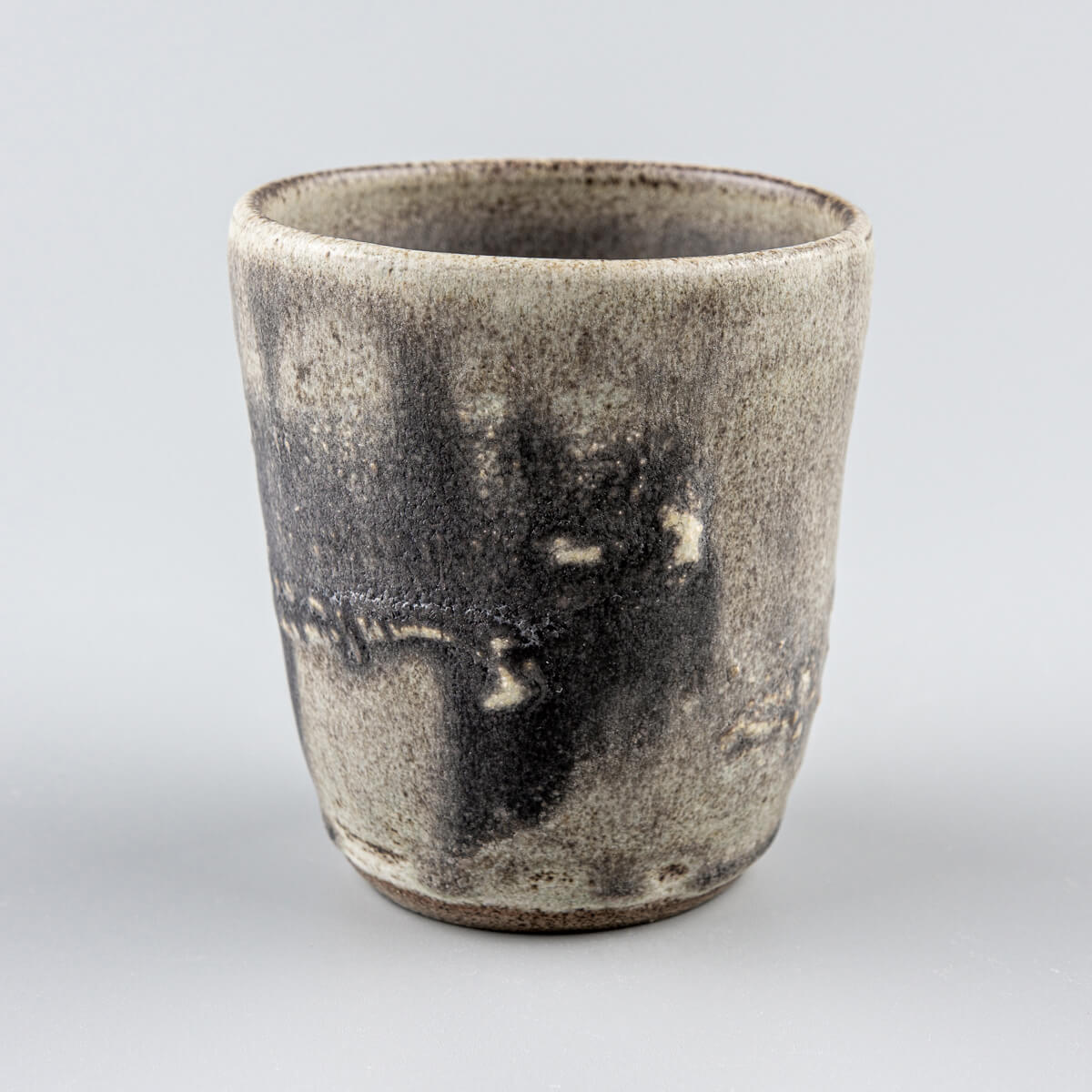 Handmade pottery cup with olive-green glaze and hakeme texture, crafted for fine dining and boutique interior design.