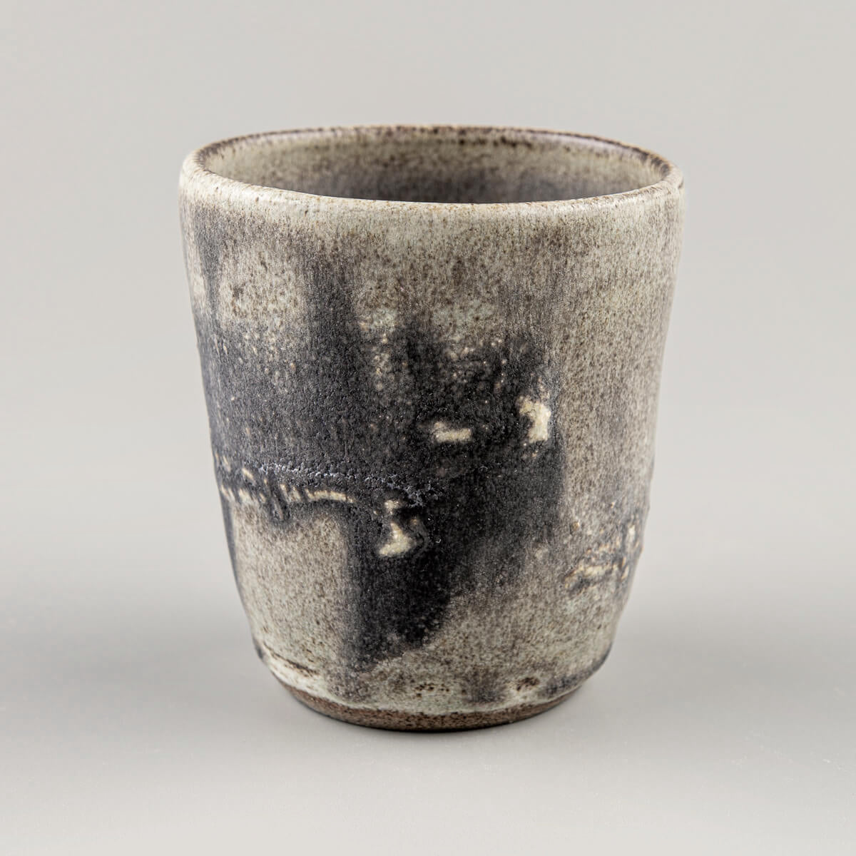 Handmade pottery cup with olive-green glaze and hakeme texture, crafted for fine dining and boutique interior design.
