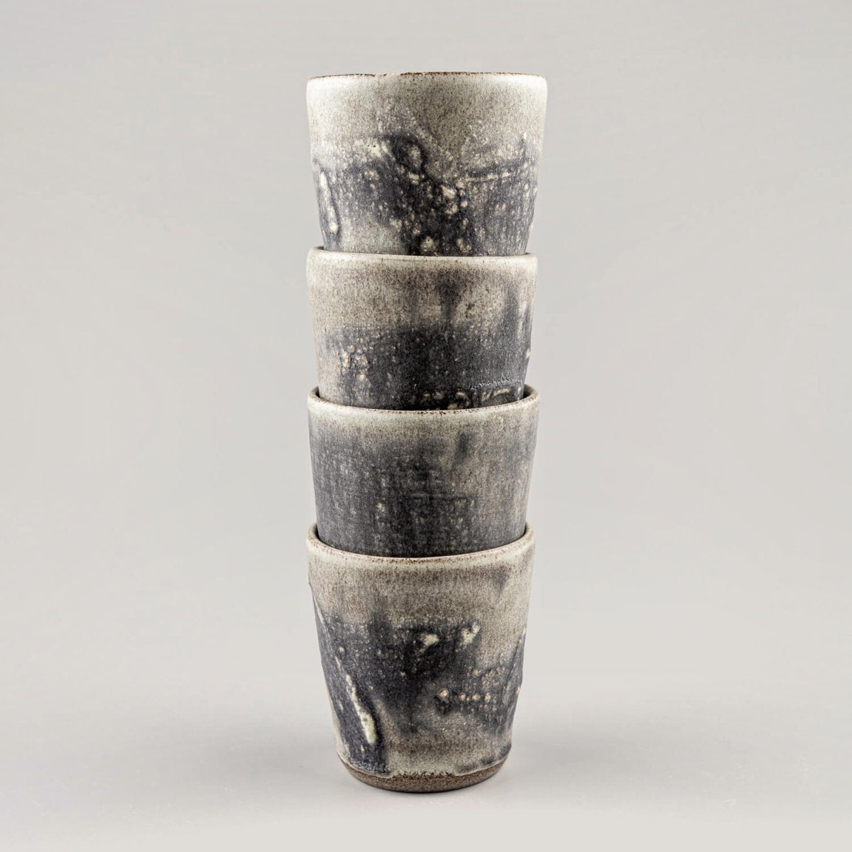 Unique handmade pottery cups with a flat base and artistic glaze, ideal for fine dining restaurants and boutique hotels.