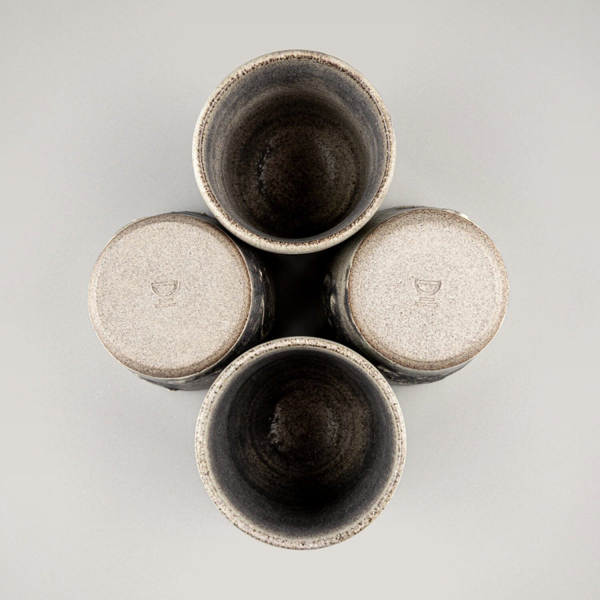Top view of pottery cups set showing rustic interior glaze and functional design for home and restaurant use.