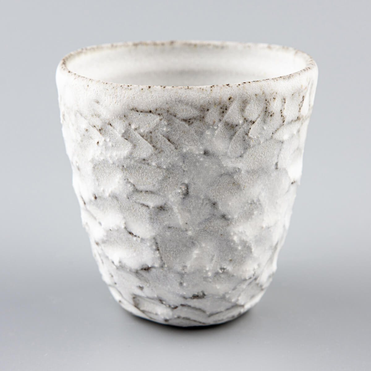 Modern rustic white stoneware mug with matte glaze finish, suited for everyday rituals and boutique hotel interiors.
