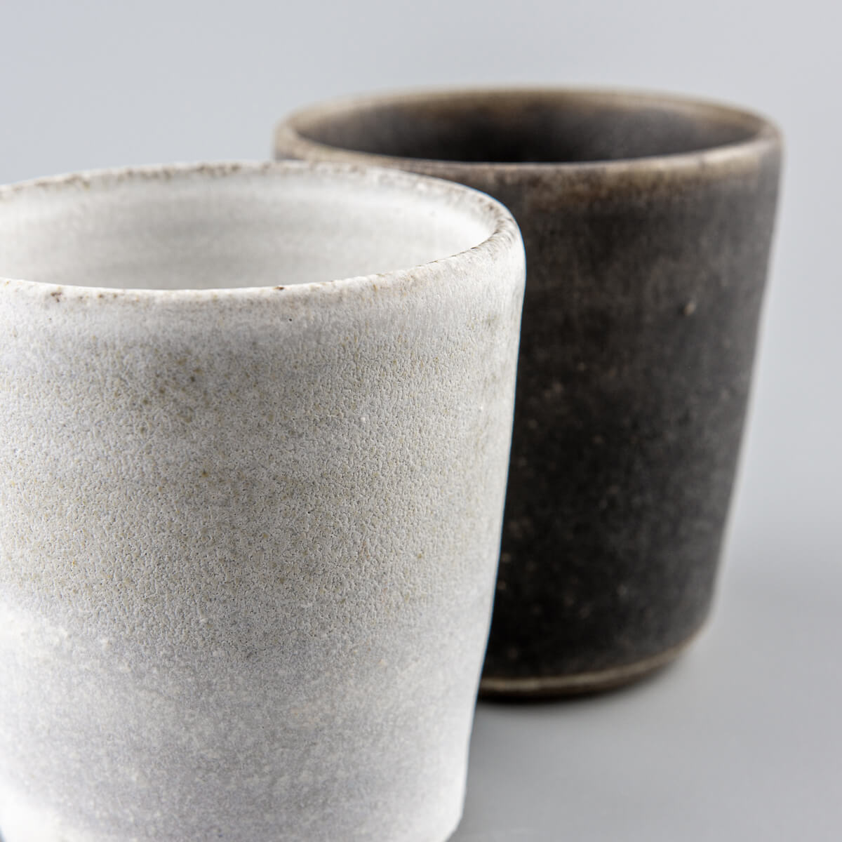 Matte white handmade pottery cup, collectible piece for interior design and private collections.