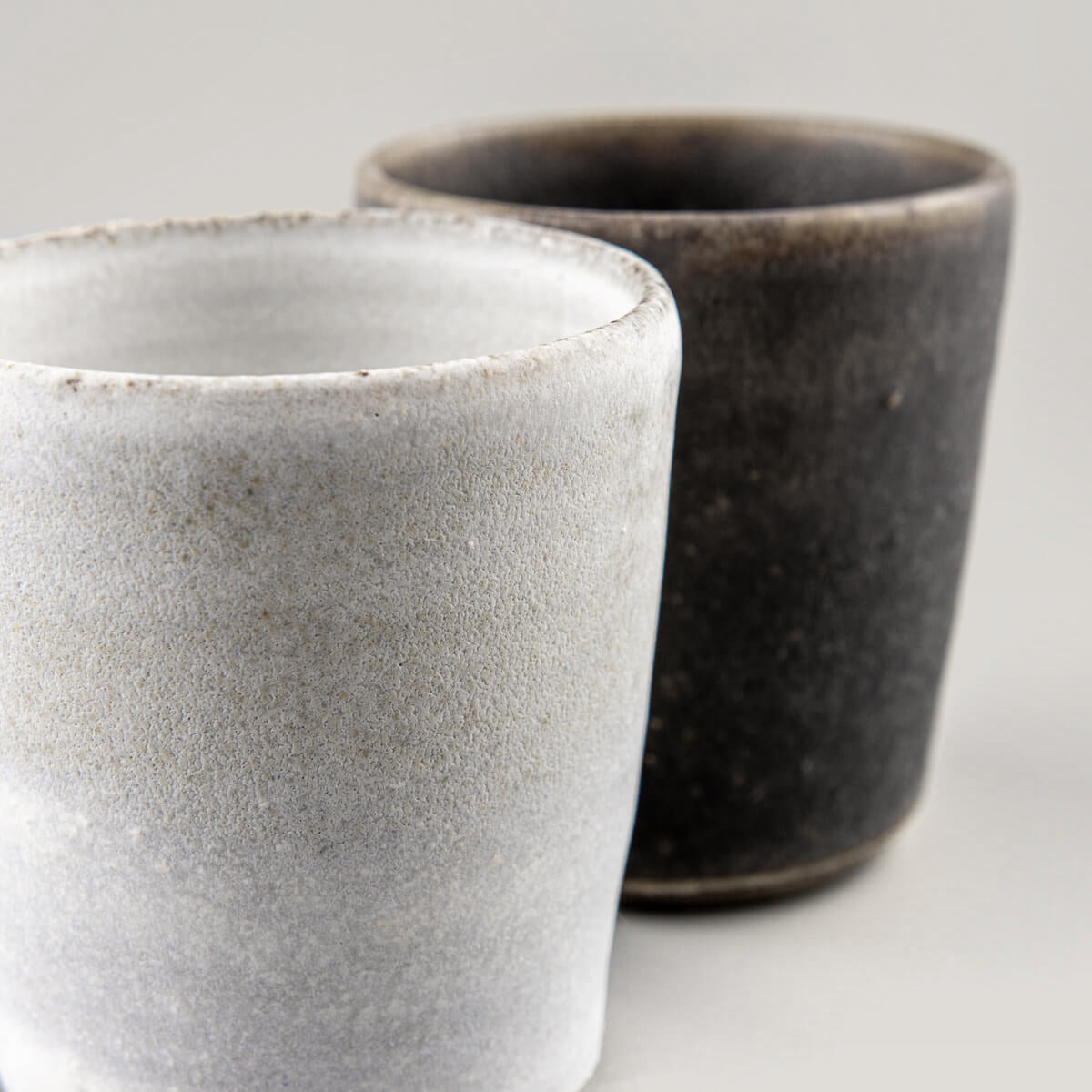 Matte white handmade pottery cup, collectible piece for interior design and private collections.