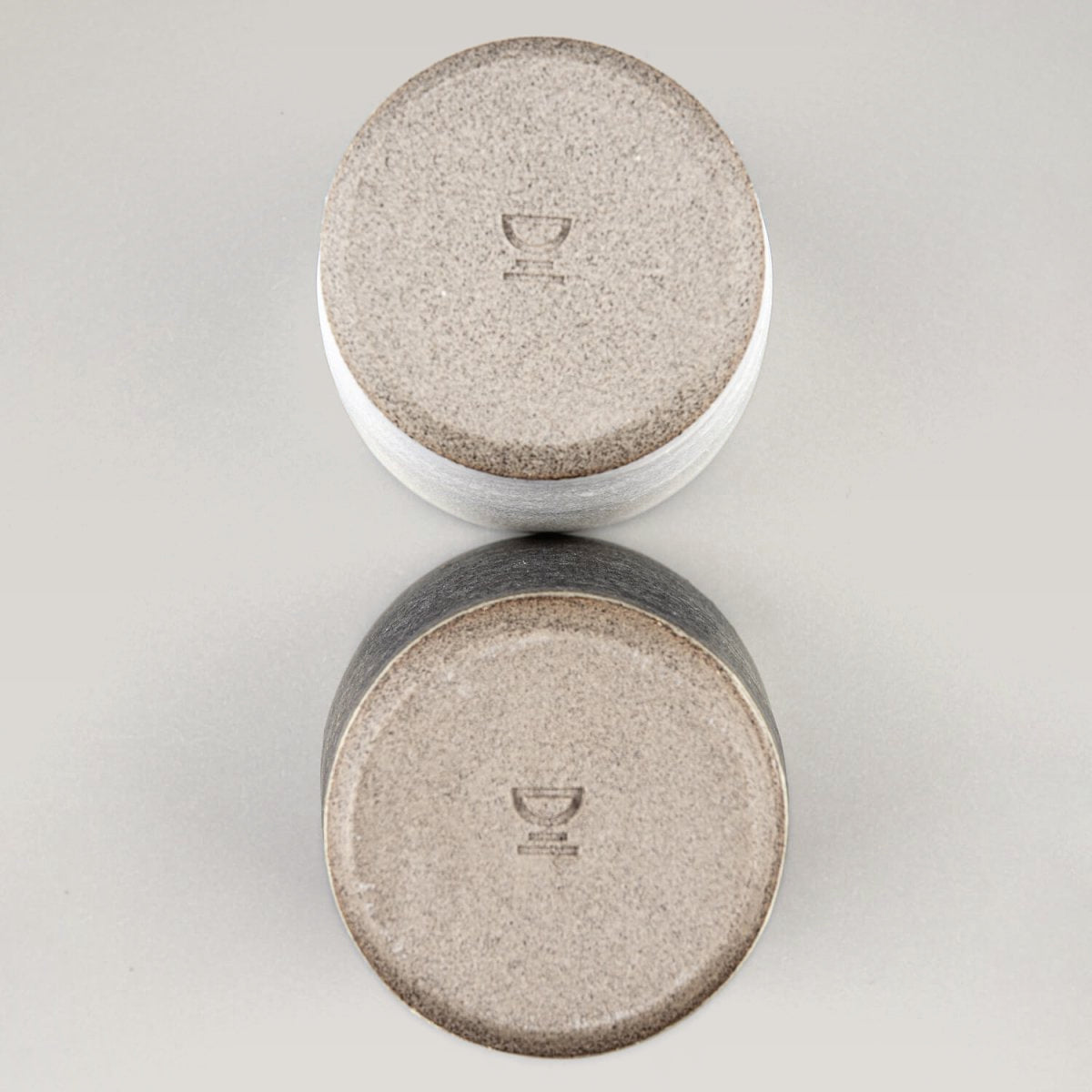 Base detail of handmade ceramic cups, showcasing artisanal craftsmanship and collectible pottery.