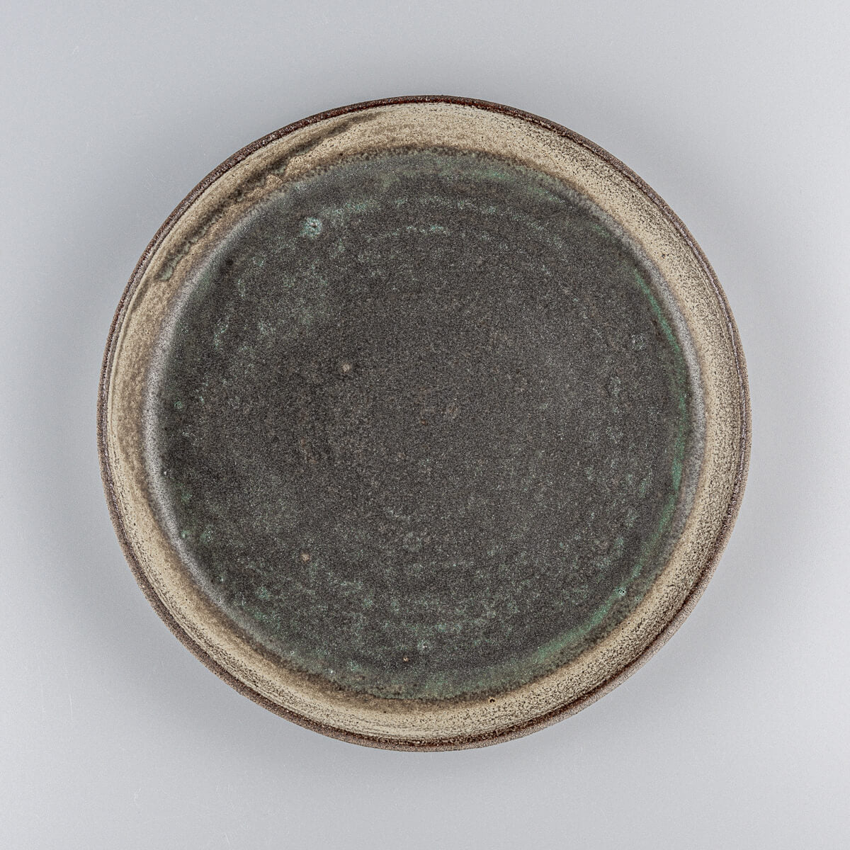 Handcrafted ceramic plate with olive-green matte glaze for fine dining and professional chefs.
