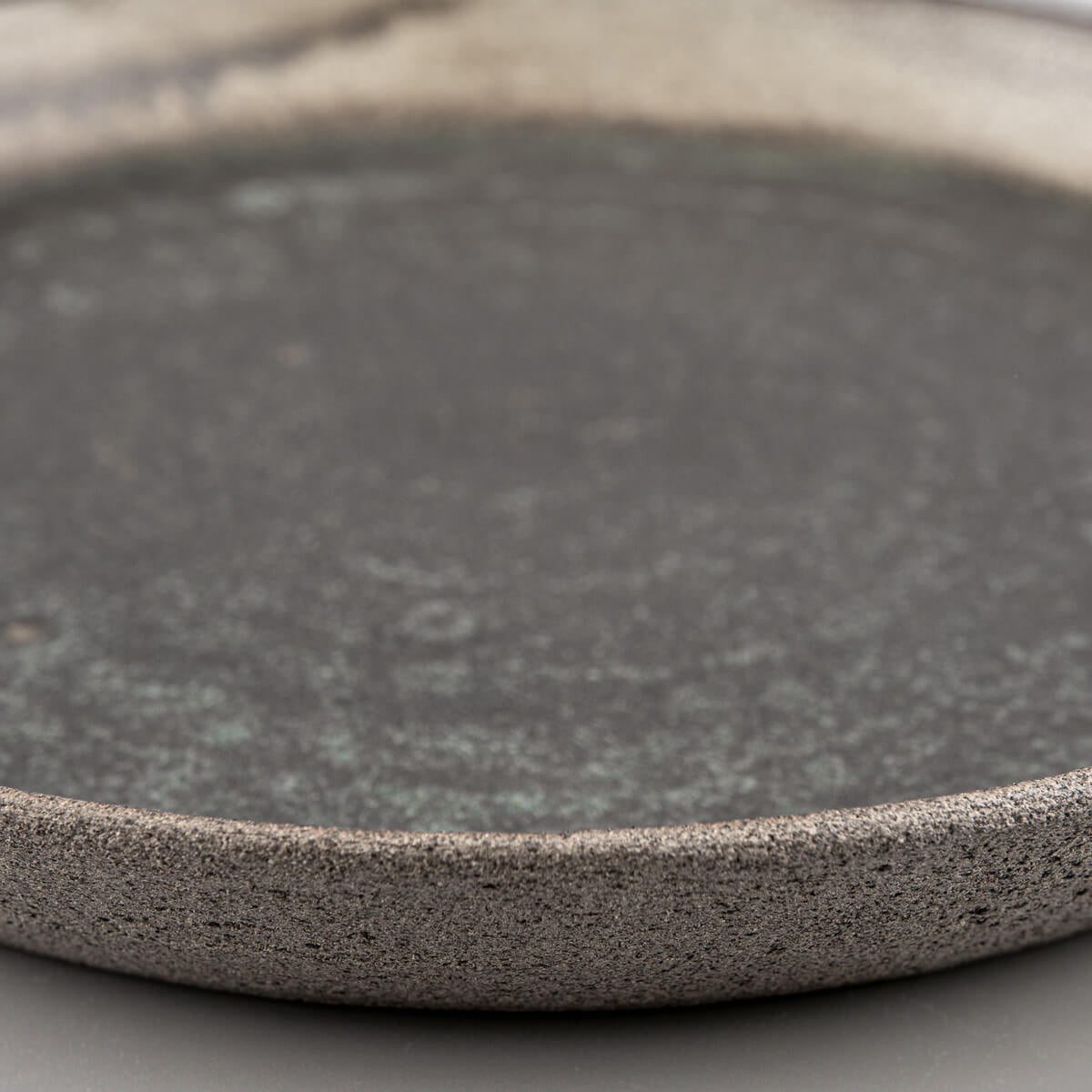 Artisan ceramic plate with unglazed exterior for natural stoneware texture.