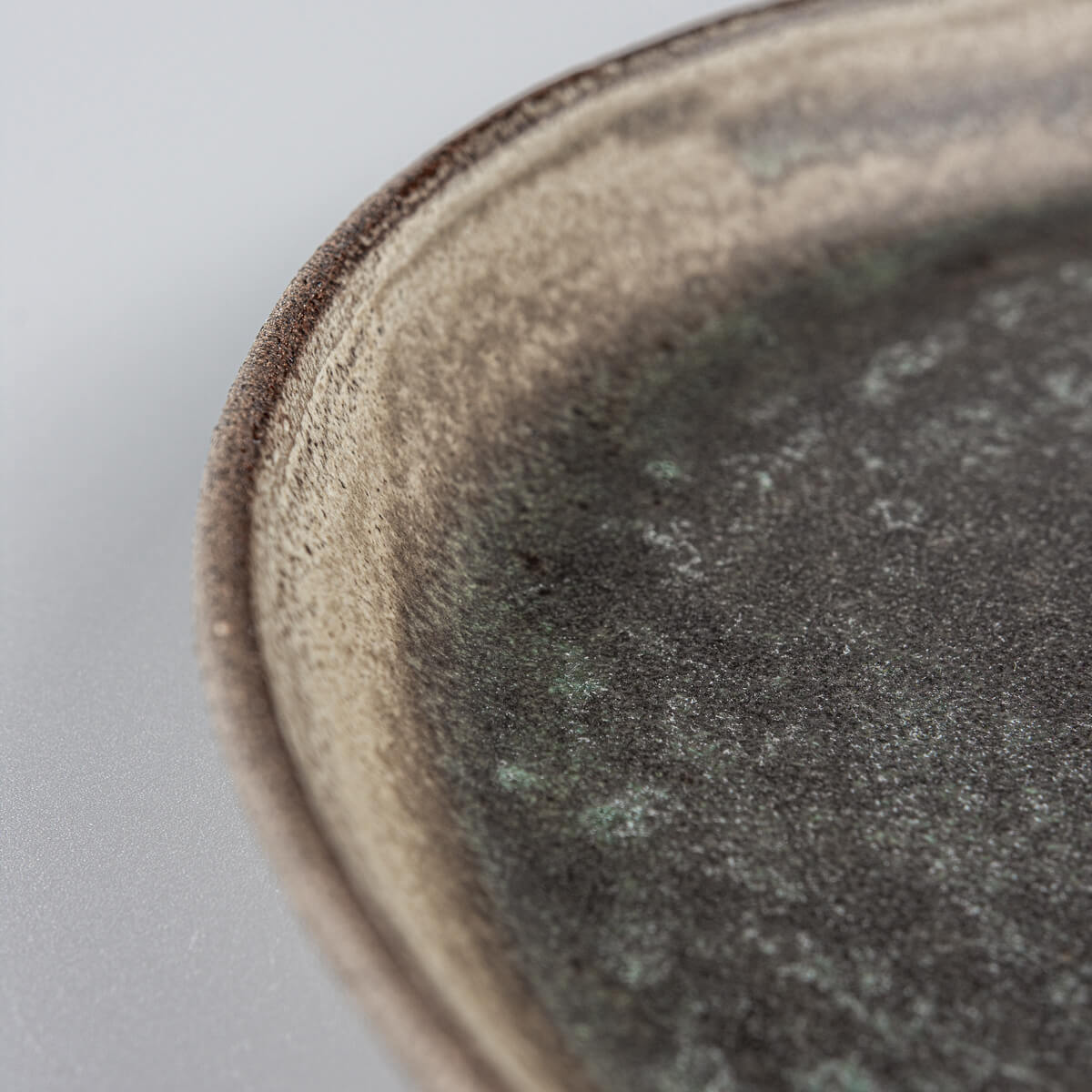 Elegant edge design on luxury handcrafted ceramic plate for restaurant use.