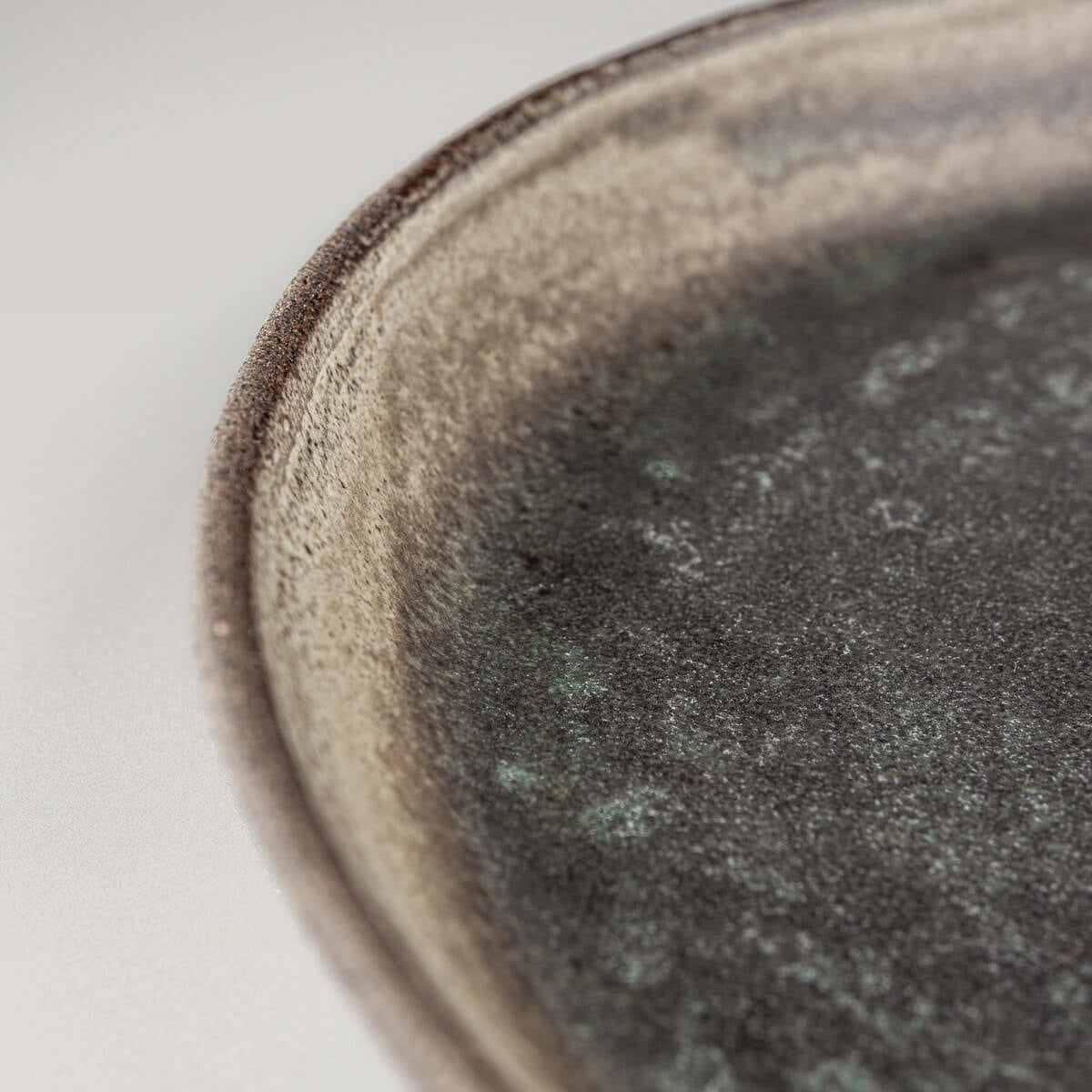 Elegant edge design on luxury handcrafted ceramic plate for restaurant use.